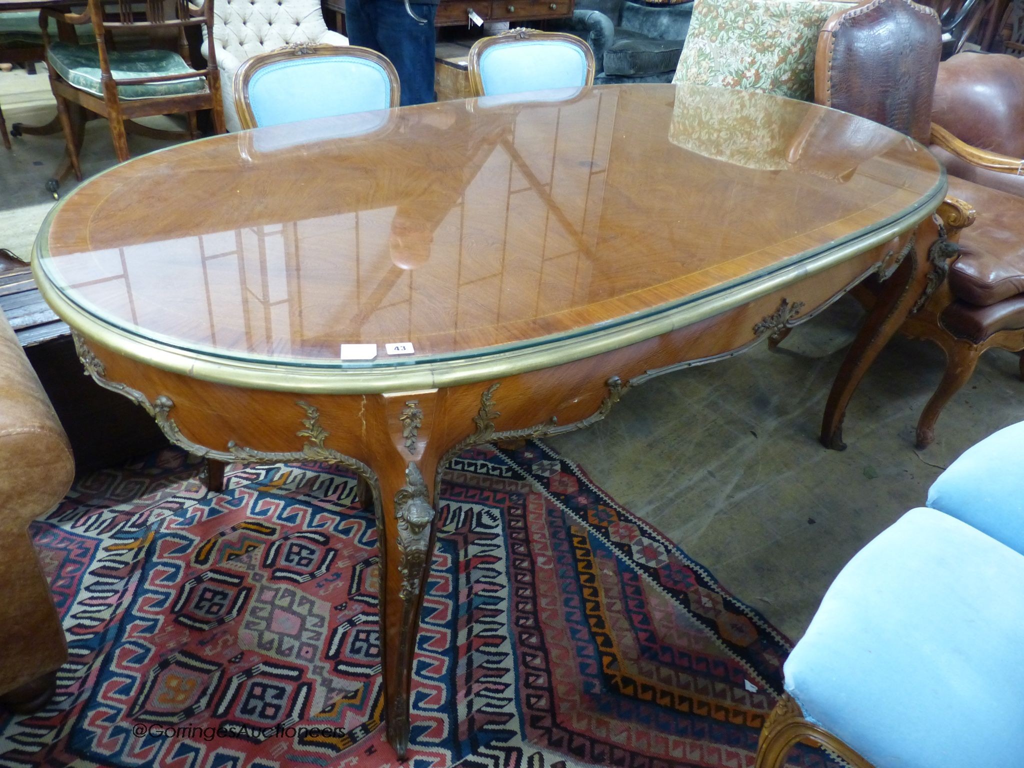 An oval gilt metal mounted Continental dining table, length 200cm, width 100cm, height 78cm